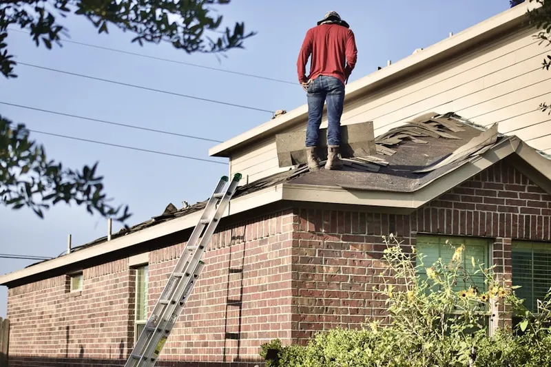 Professional roofer working on a residential roof in Cinco Ranch